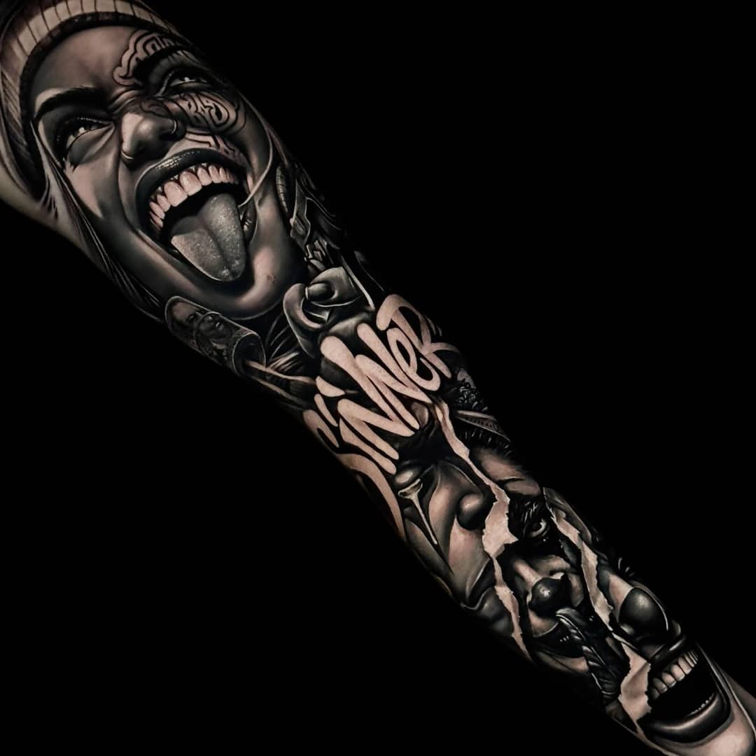 Chicano leg sleeve with Smile Now Cry Later, payasa, LA skyline, lowrider, roses, and praying hands at Bloodline Tattoo Phuket