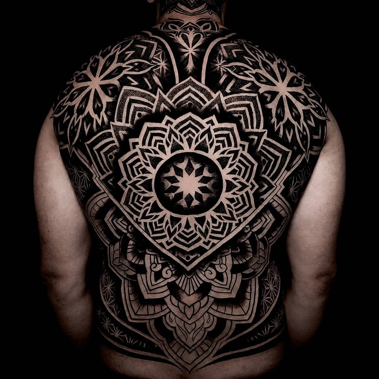Mandala tattoo with symmetrical linework and controlled negative space at Bloodline Tattoo Phuket