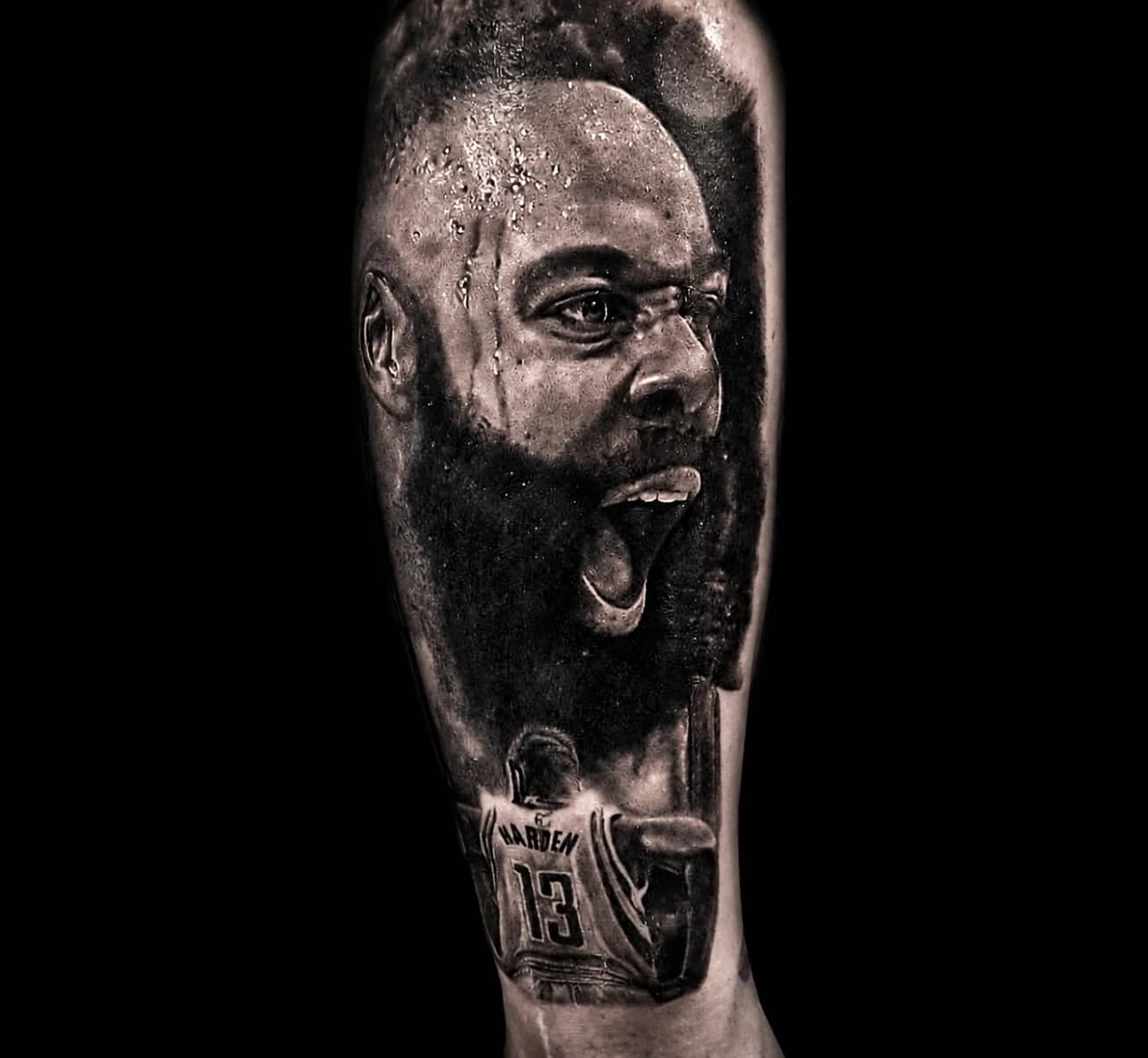 Black and grey JJ Watt 99 portrait realism with eye black and nose tape at Bloodline Tattoo Phuket