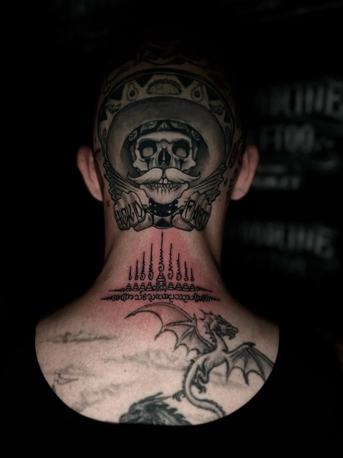 Fresh Gao Yord (Nine Spires) Sak Yant with nine peaked unalomes and Khom script on the nape of the neck at Bloodline Tattoo Phuket.