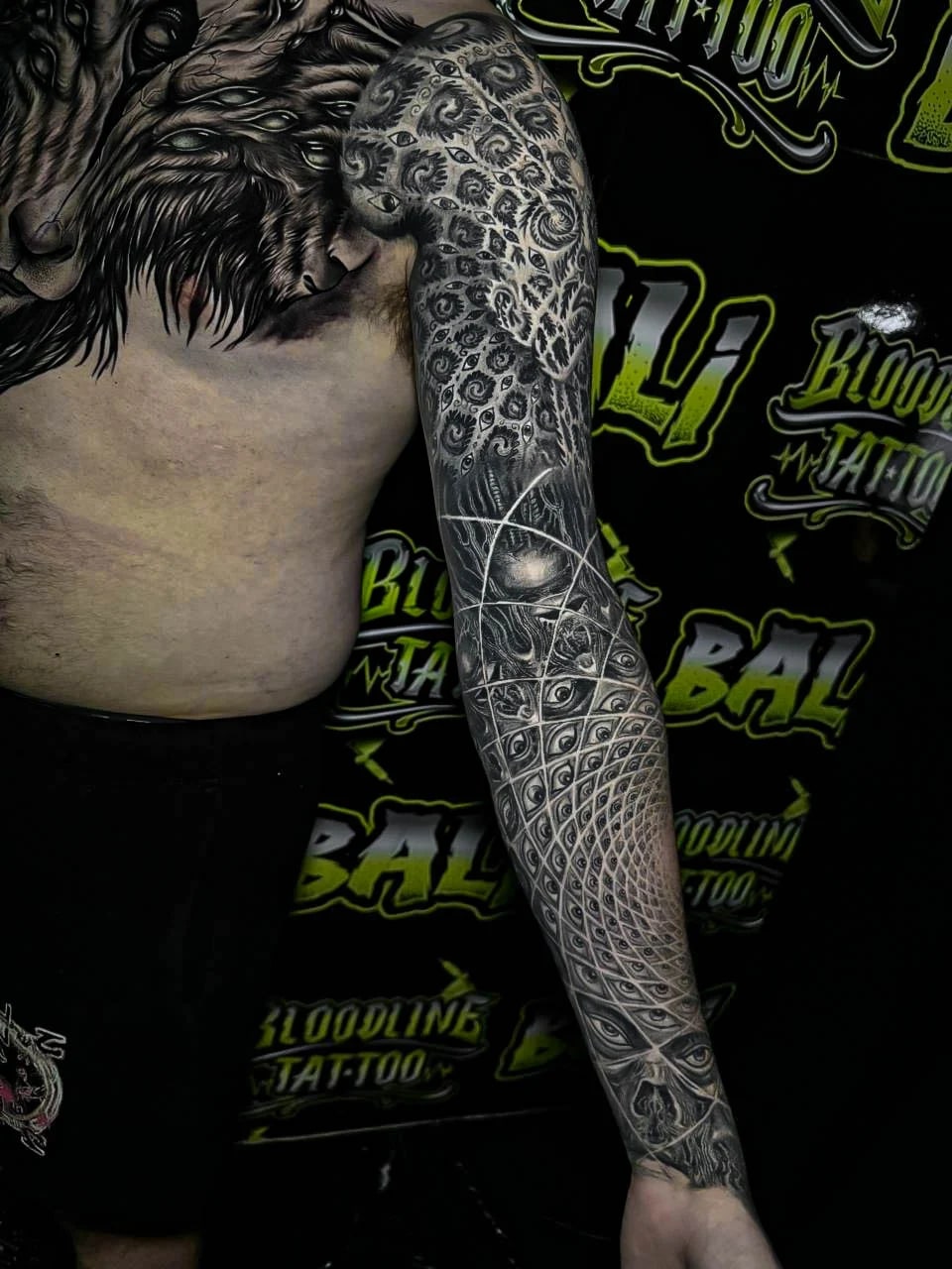 Healed surreal sleeve with multi-eye geometry, filigree texture, and spiral latticework, showing crisp healed line integrity through the forearm at Bloodline Tattoo Bali.