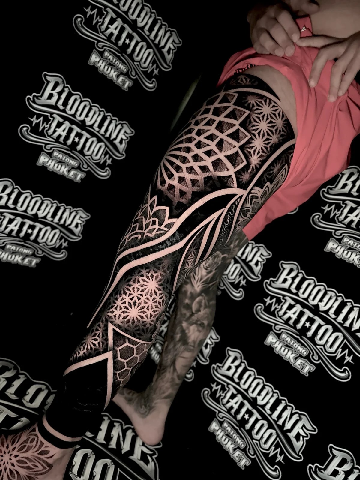Geometric mandala leg sleeve with thigh 3D cube patterns, circular dotwork mandalas, and a foot mandala in high-contrast blackwork at Bloodline Tattoo Phuket.