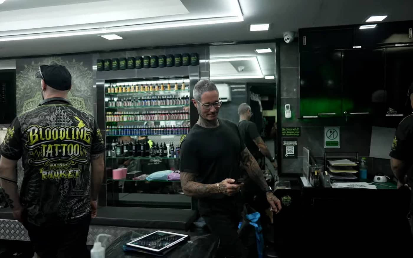Bright professional Bloodline Tattoo Phuket studio interior with organised ink wall and staff