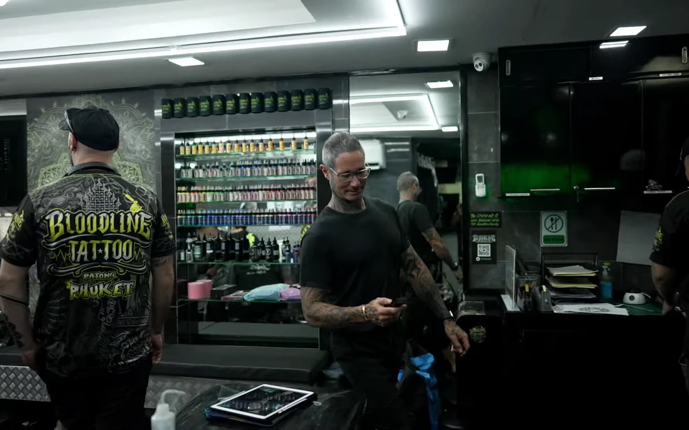 Bright professional Bloodline Tattoo Phuket studio interior with organised ink wall and staff