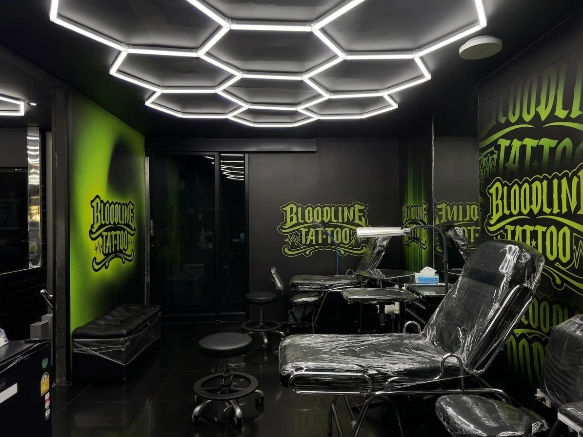 Bloodline Tattoo Phuket branded interior room with clean stations and hexagonal ceiling lights