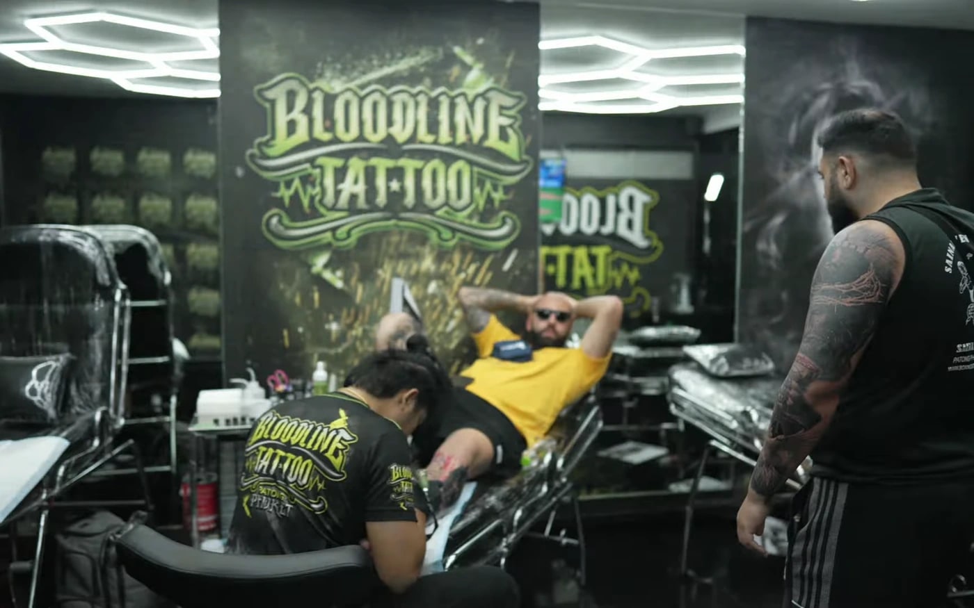 Tattoo session in progress at Bloodline Tattoo Phuket under hexagonal studio lights