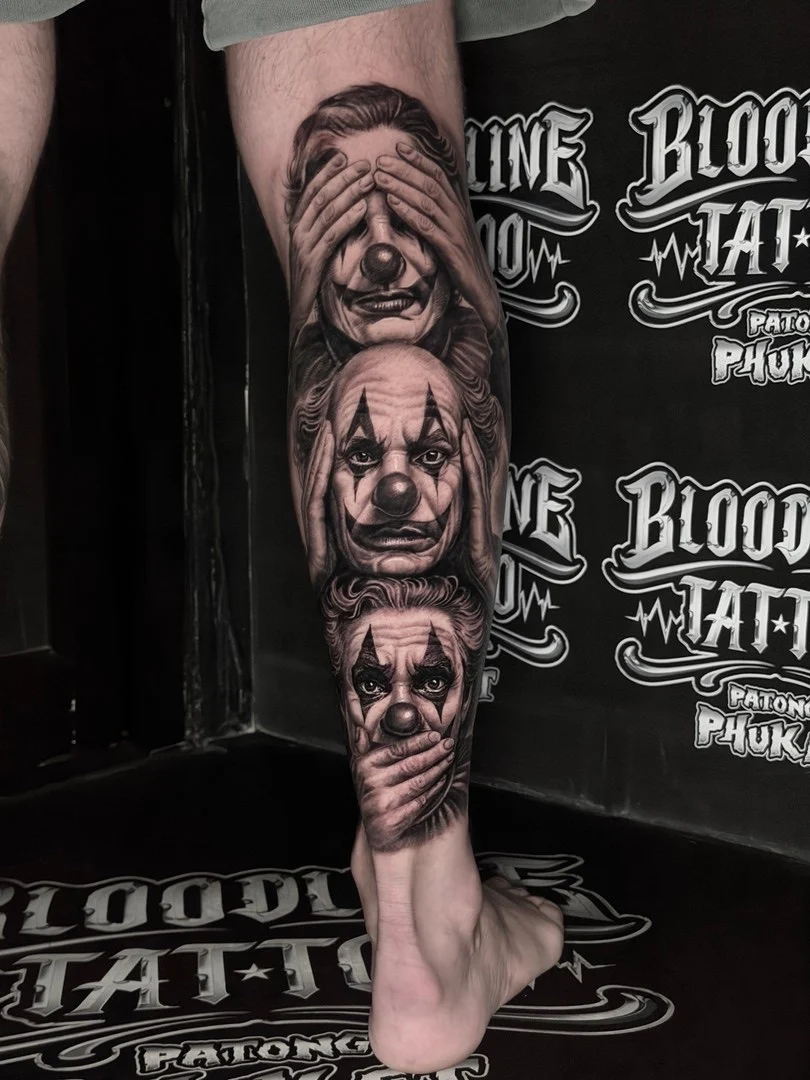 Black and grey portrait realism calf tattoo of Joker clown faces in see-no-evil, hear-no-evil, speak-no-evil poses at Bloodline Tattoo Phuket.